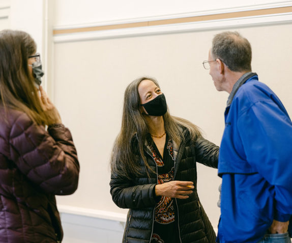 Three people in a room.